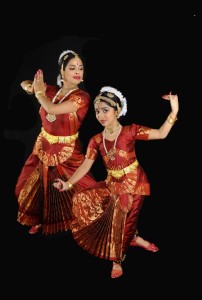 Two Bharatanatyam dancers in red.