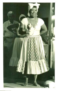 young Blanche Brown holds shaker and sings