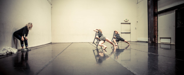 Sara Shelton Mann watches two dancers on chairs