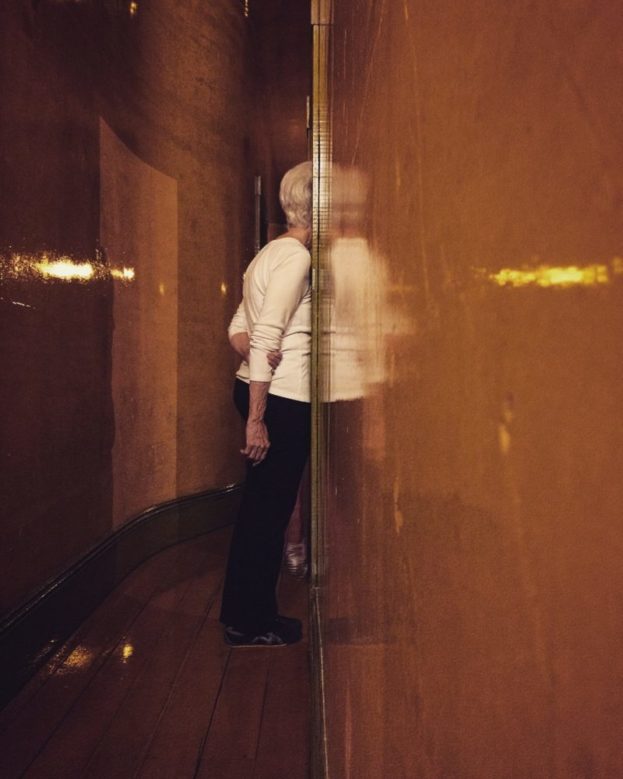 older woman leans into doorway
