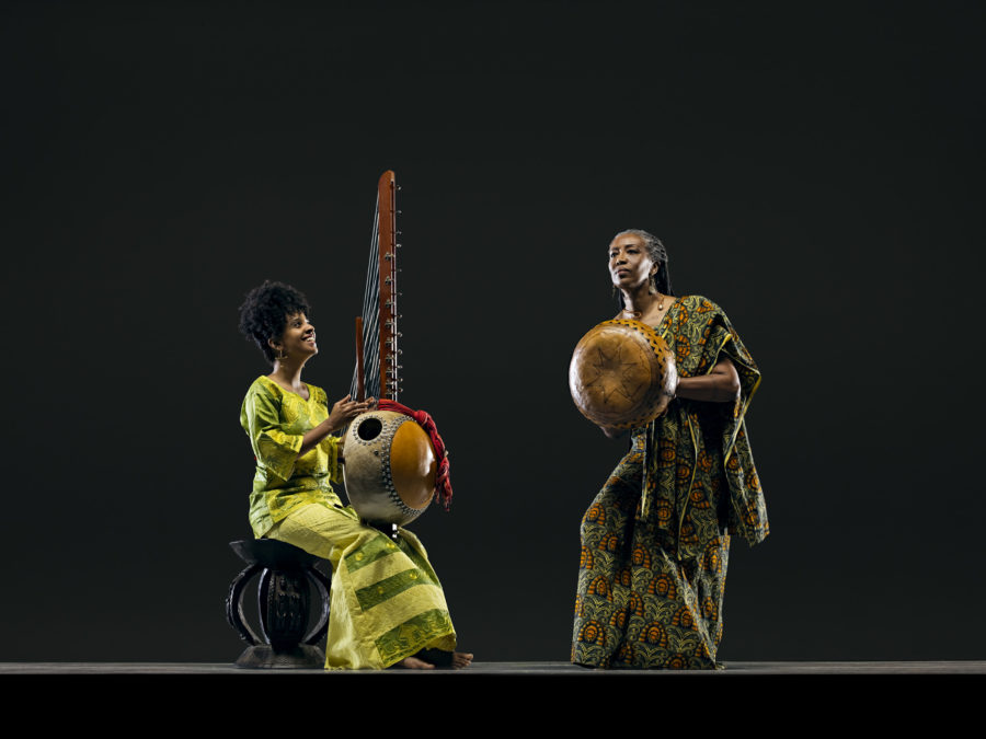 seated and standing women play traditional instruments