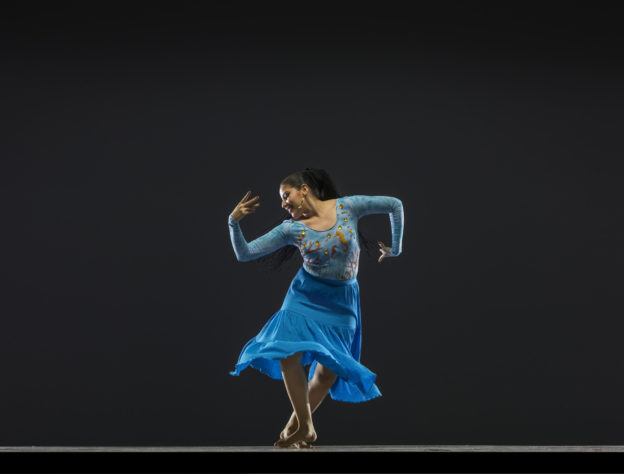 Dancer in blue performing on stage