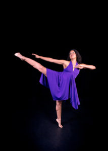 solo african american female dancer in purple flowing dress