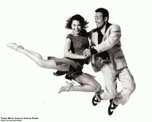 an african american couple leaping in the air