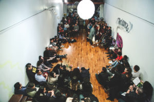Many people gathered in a circle in Studio Grand.