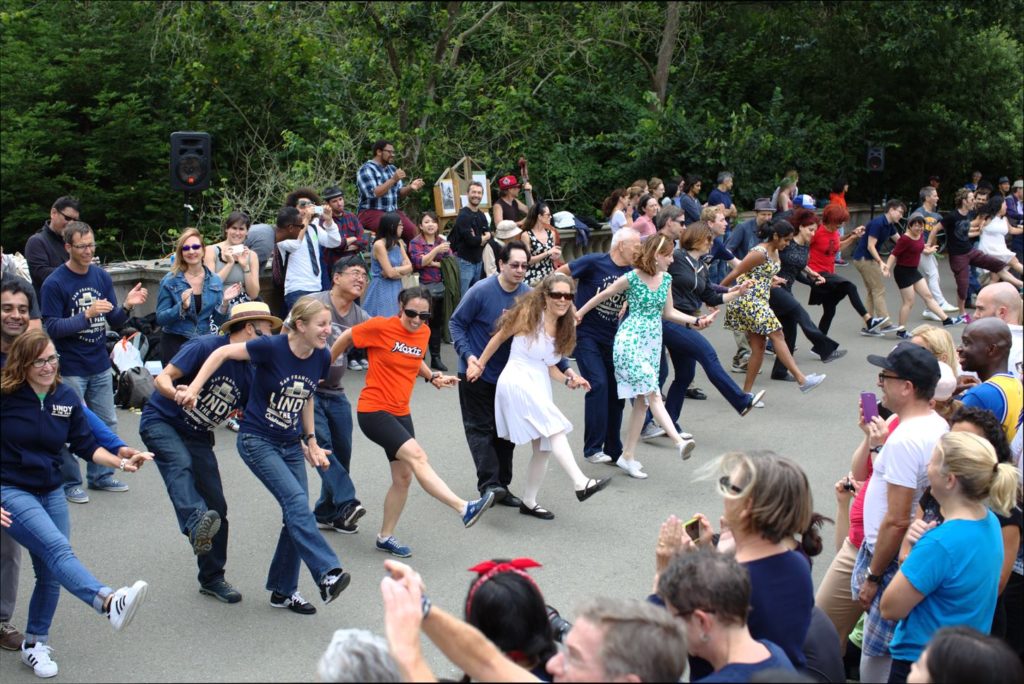 A crowd watches a large group doing Lindy Hop in San Francisco's Golden Gate Park