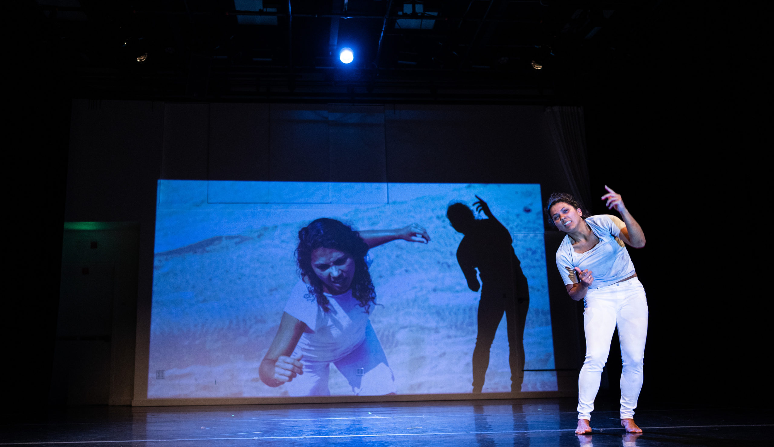 Dancer in front of a projection screen