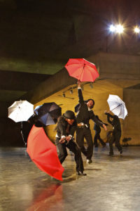 People dancing with umbrellas in Anna Halprin's "Parades and Changes"