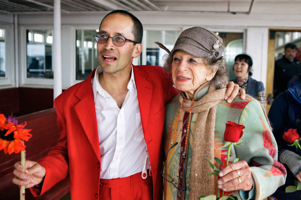 Anna Halprin and a person in a red suit 