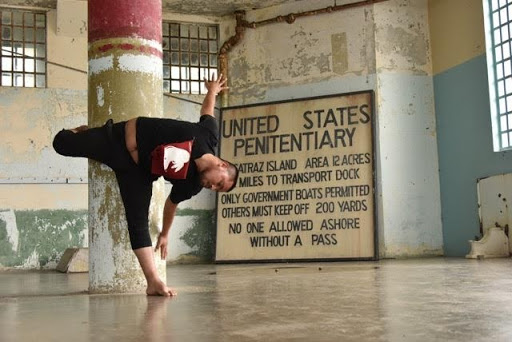 Male dancer wrapped around a column at Alcatraz
