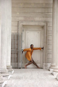 Dancer ArVejon Jones poses in a doorway flanked by marble columns