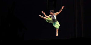 Performance photo of Joslynn Mathis in mid-leap 