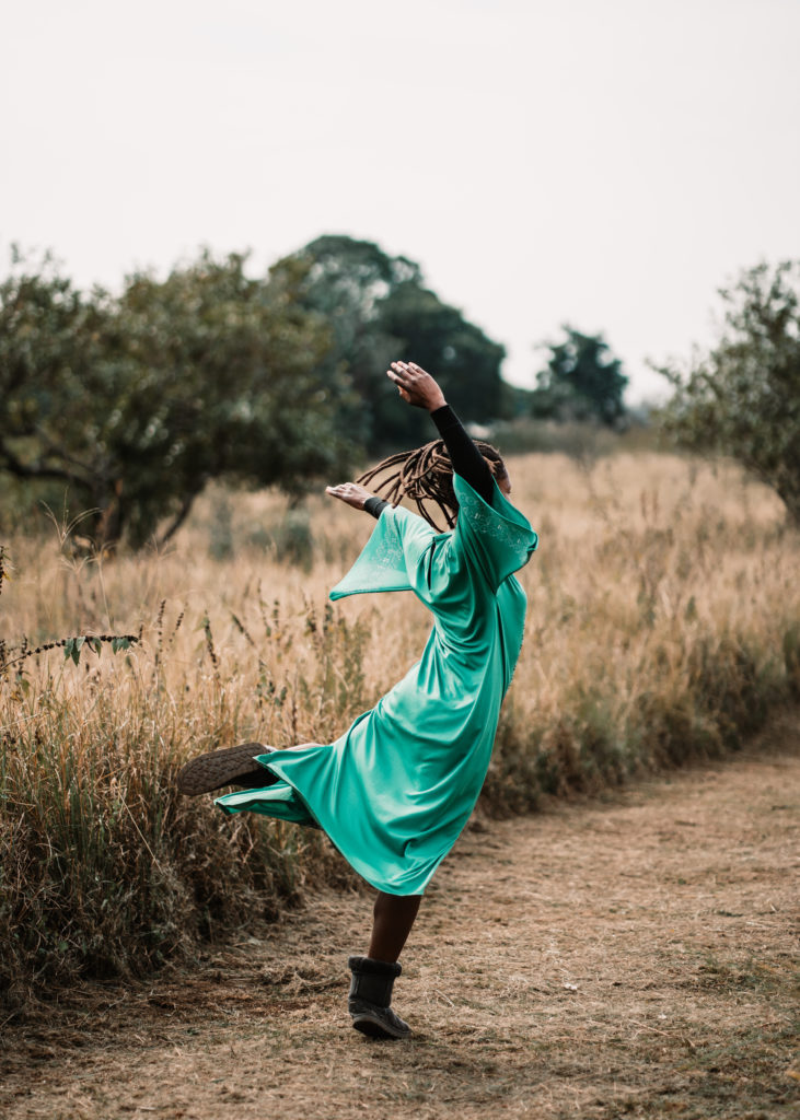 Woman spinning in out in the savanna