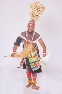 Nigerian Igbo cultural dancer against plain white background