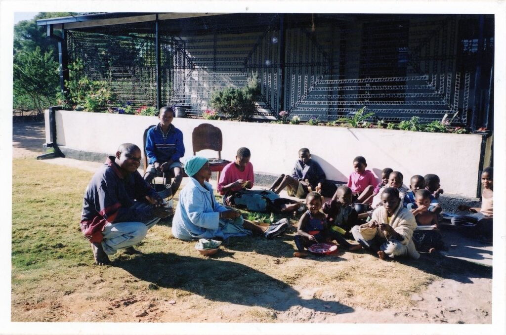 Laiza Muchenje-Chigamba sitting at her home with her grandchildren