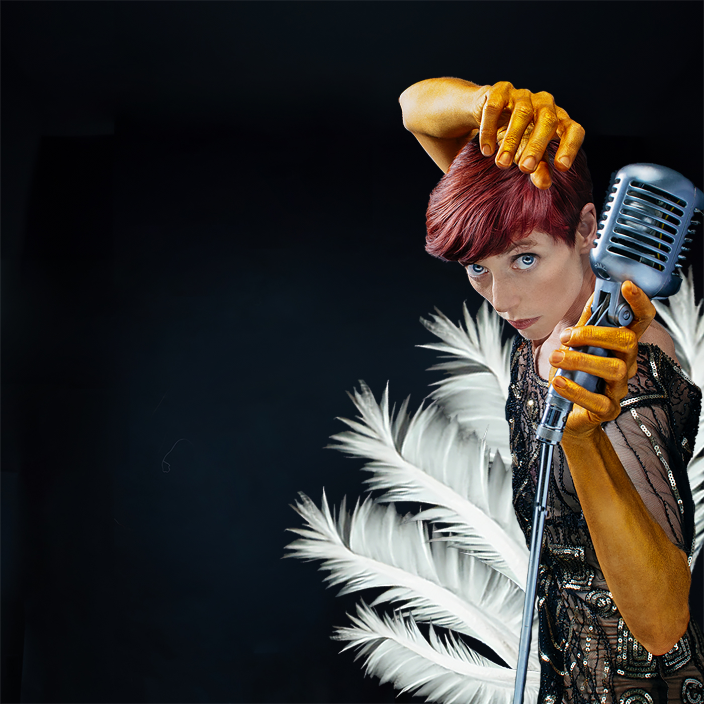 Dancer in sequins surrounded by feathers holds an old fashioned microphone