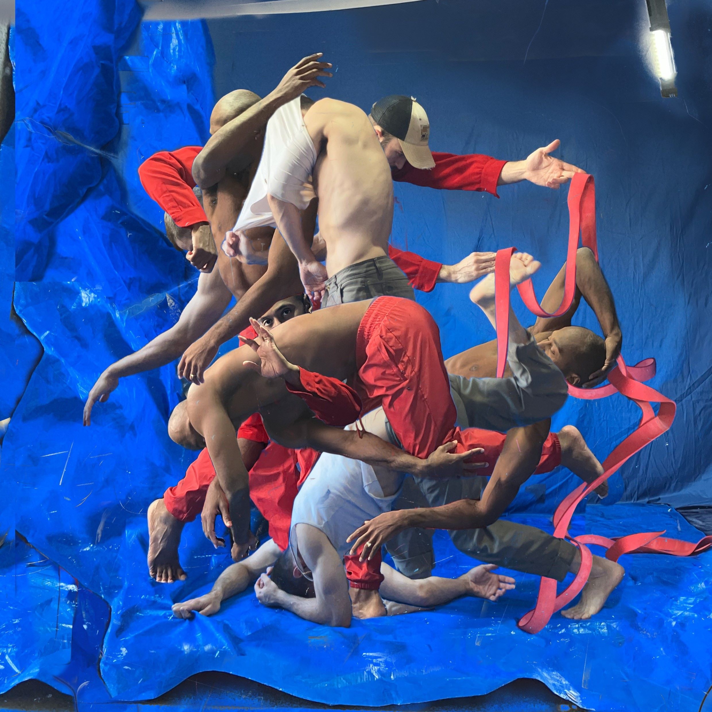 Photo collage of two dancers' bodies intertwined multiple times in a bright studio space.