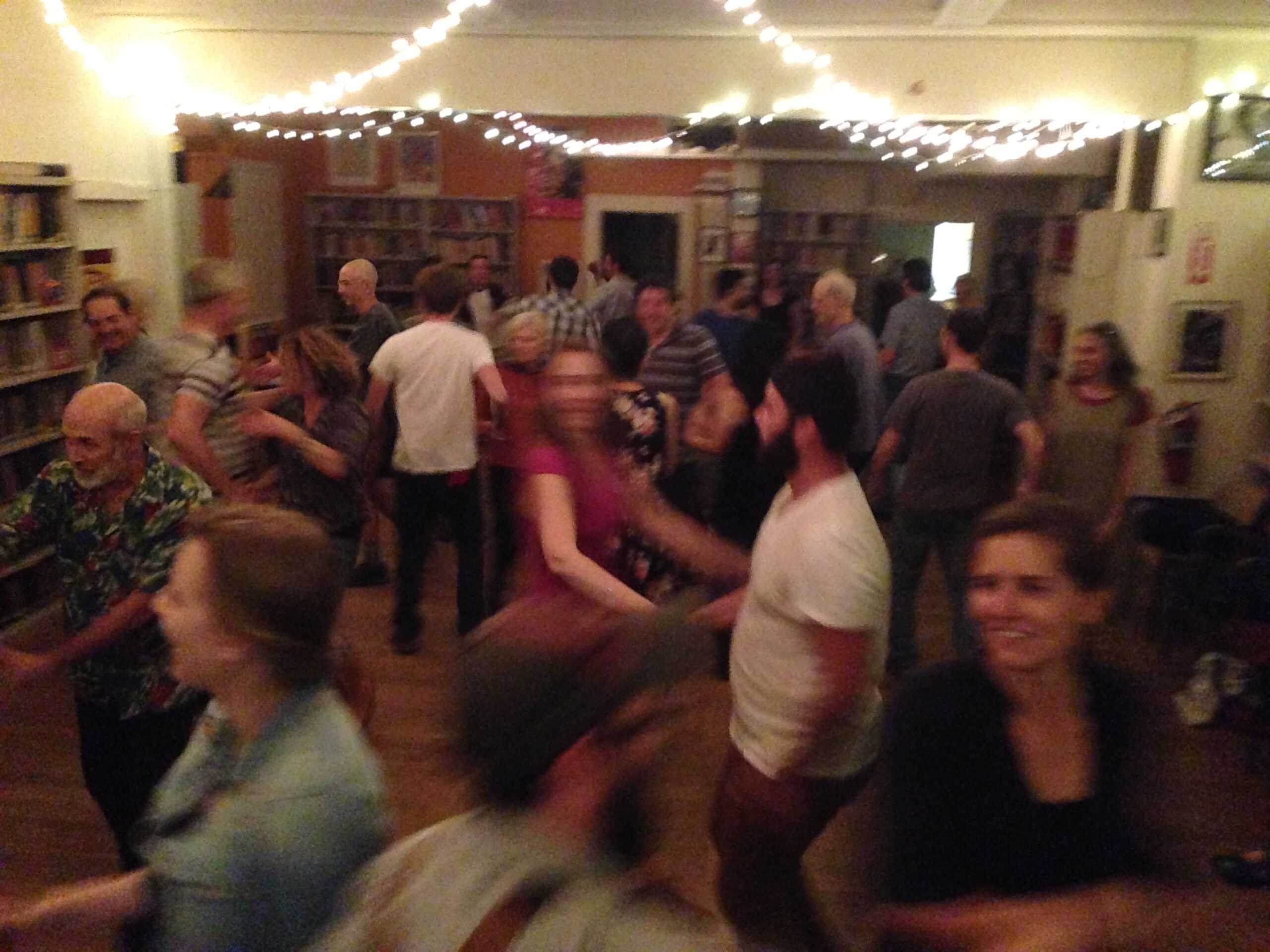 Many people enjoying square dancing at the Marxist Library