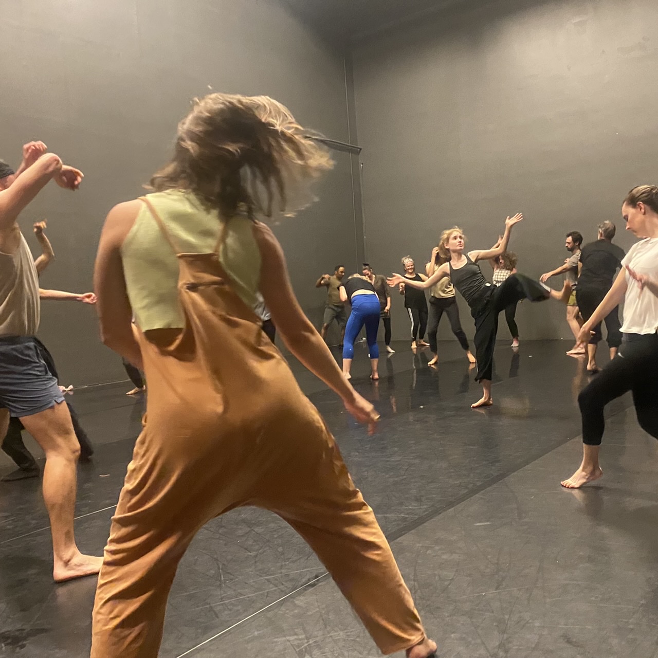 Dancers moving freely  in a studio