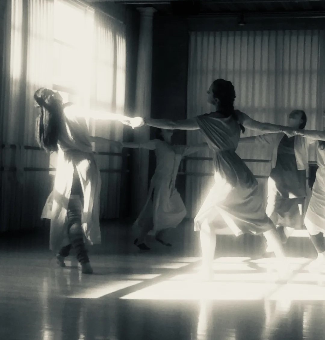 This black and white photo is of dancers running in a circle while holding hands at the Mary Sano Studio of Duncan Dancing.