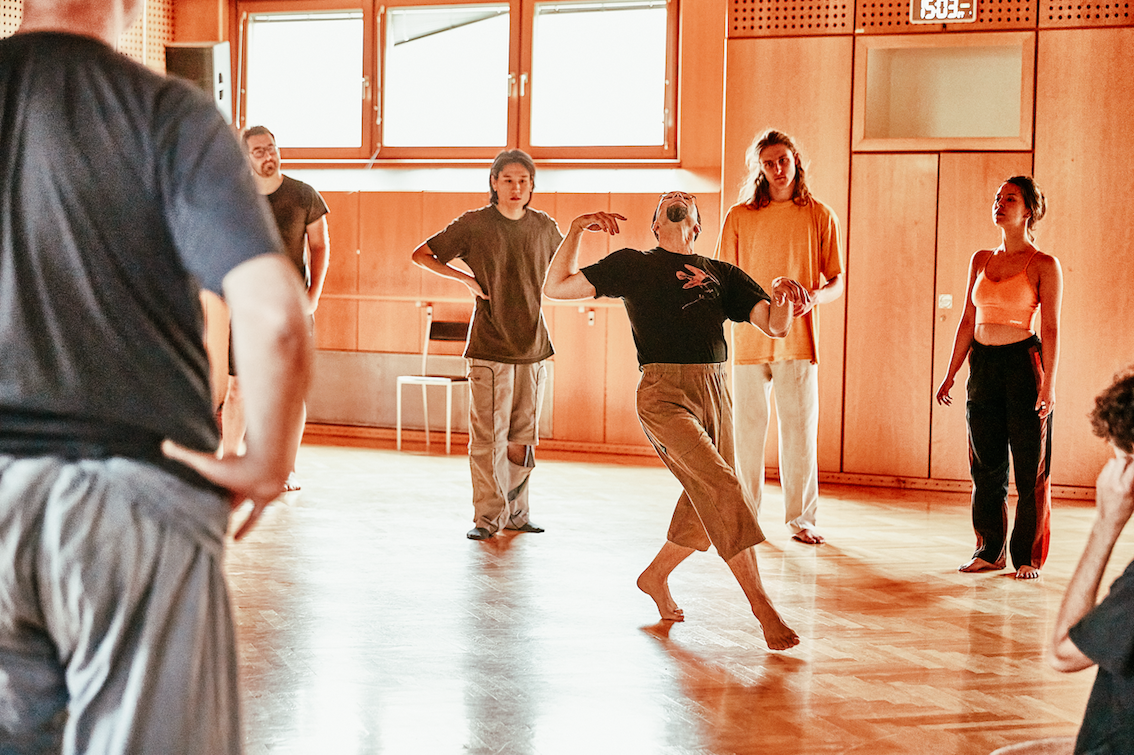 Shinichi demonstrating a movement to students.