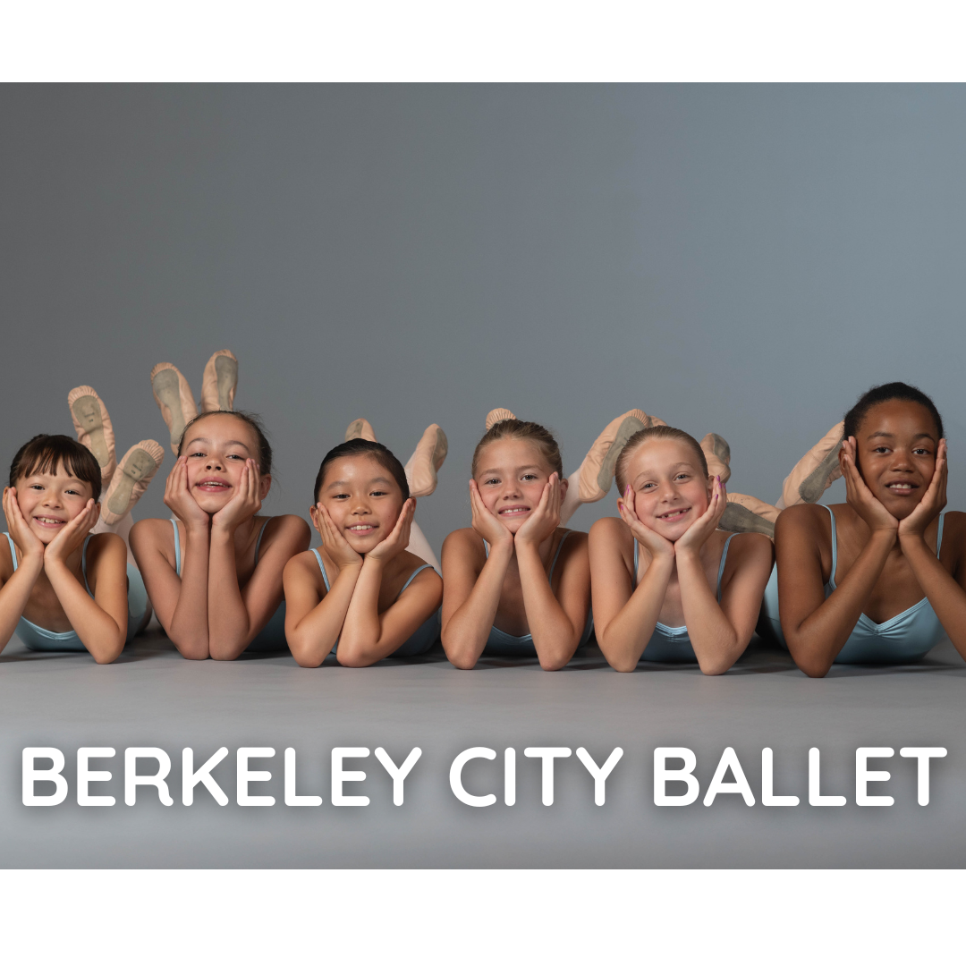 Group of dancers smiling while laying down on the floor