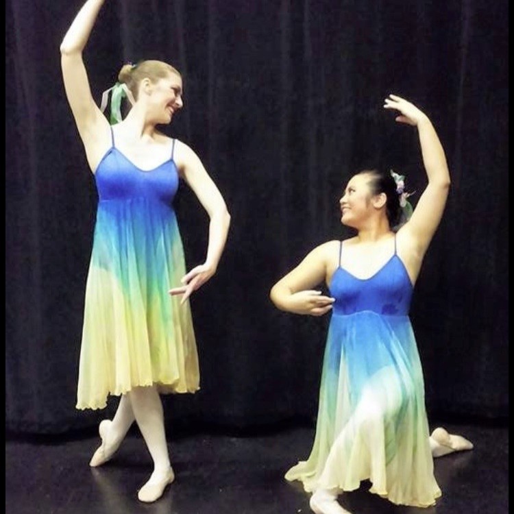 2 adult female dancers holding ballet poses