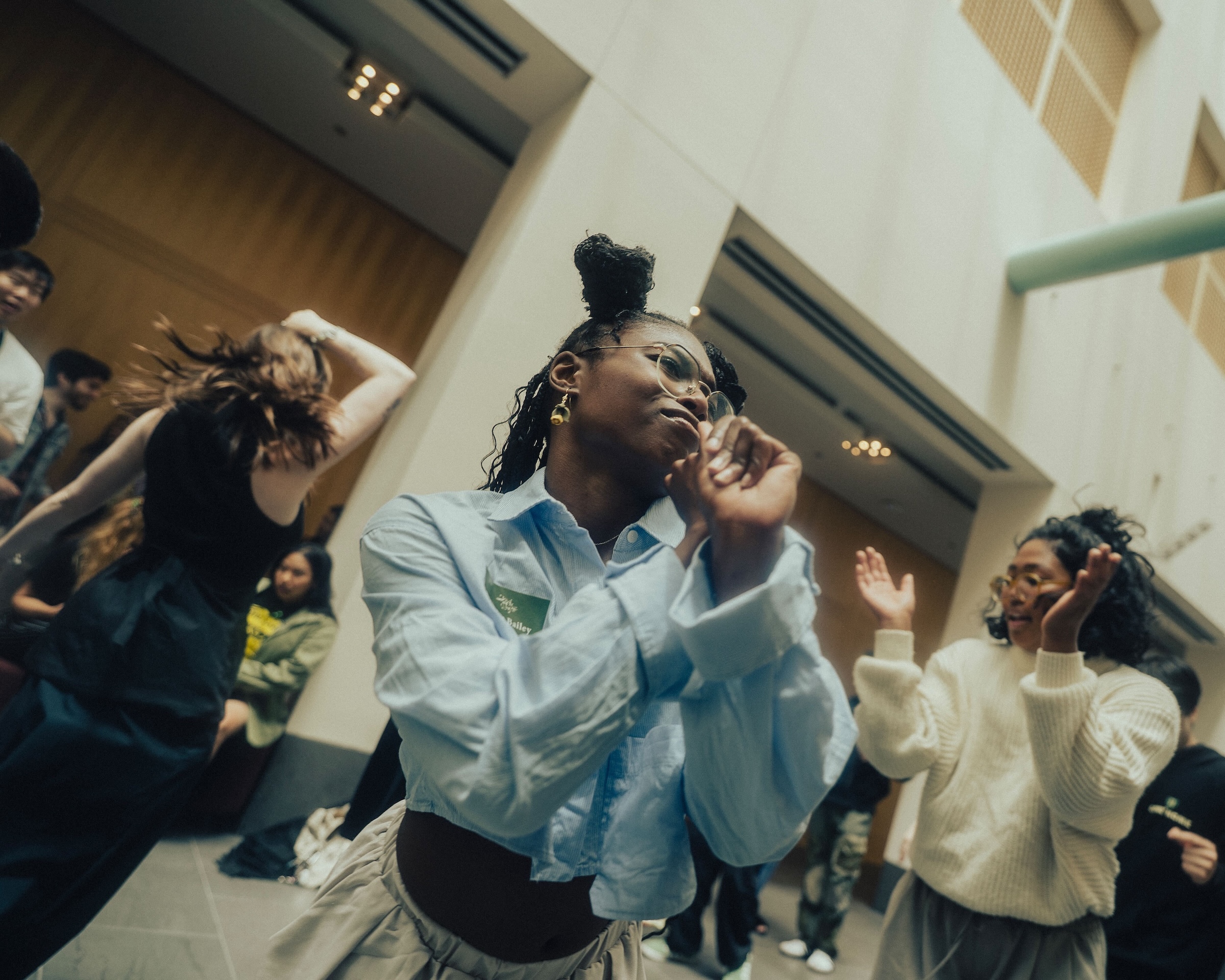 Instructor Jessica Bailey dancing with other dancers in background.