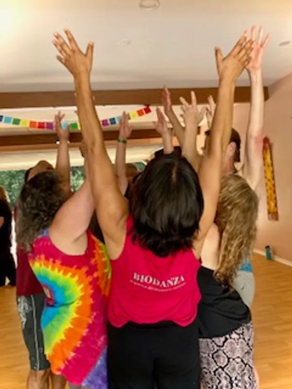 Circle of people with hands up