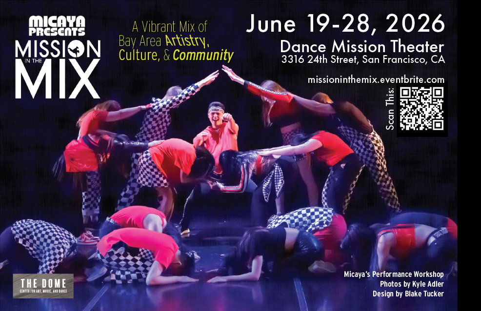 14 dancers crouched and standing around one dancer creating a vehicle effect