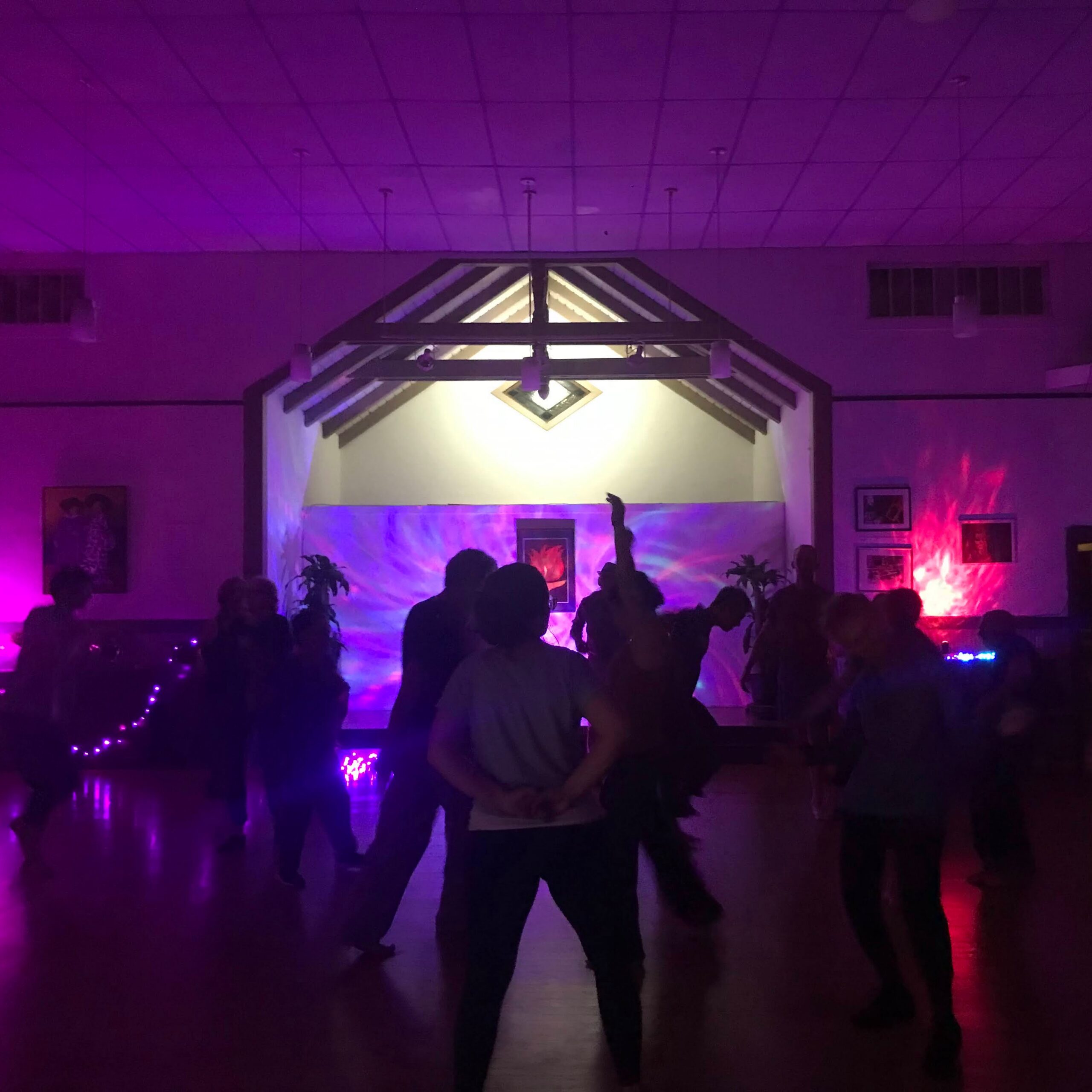 A group of people dancing in a dark room
