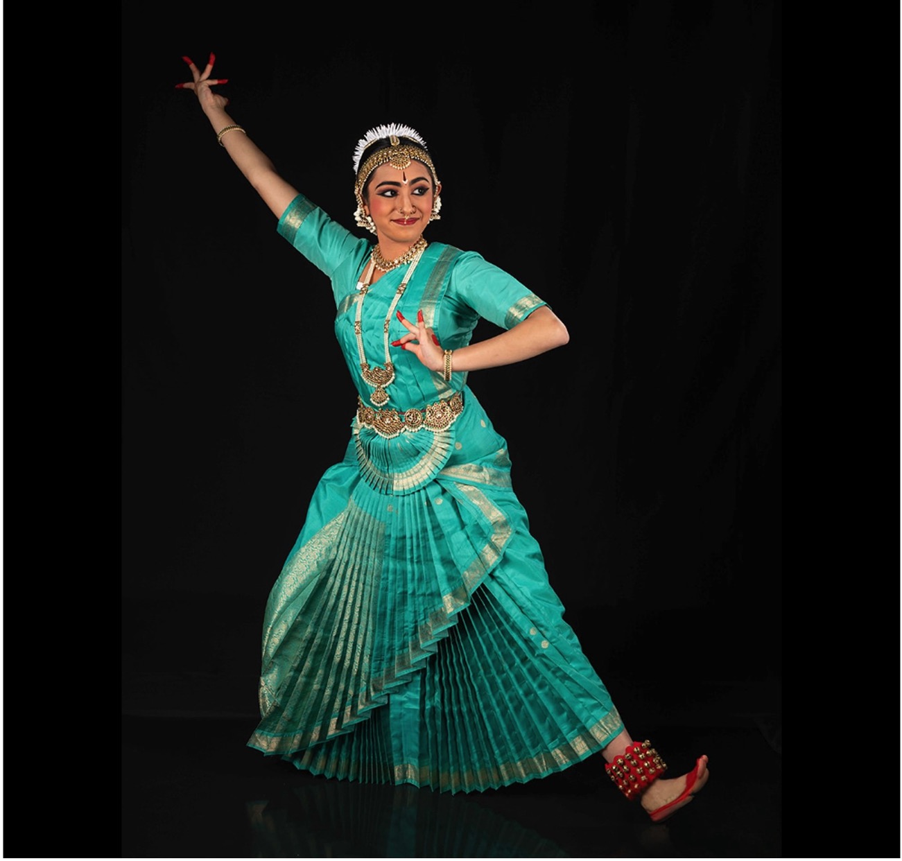 Dancer in a teal blue bharatanatyam dress 