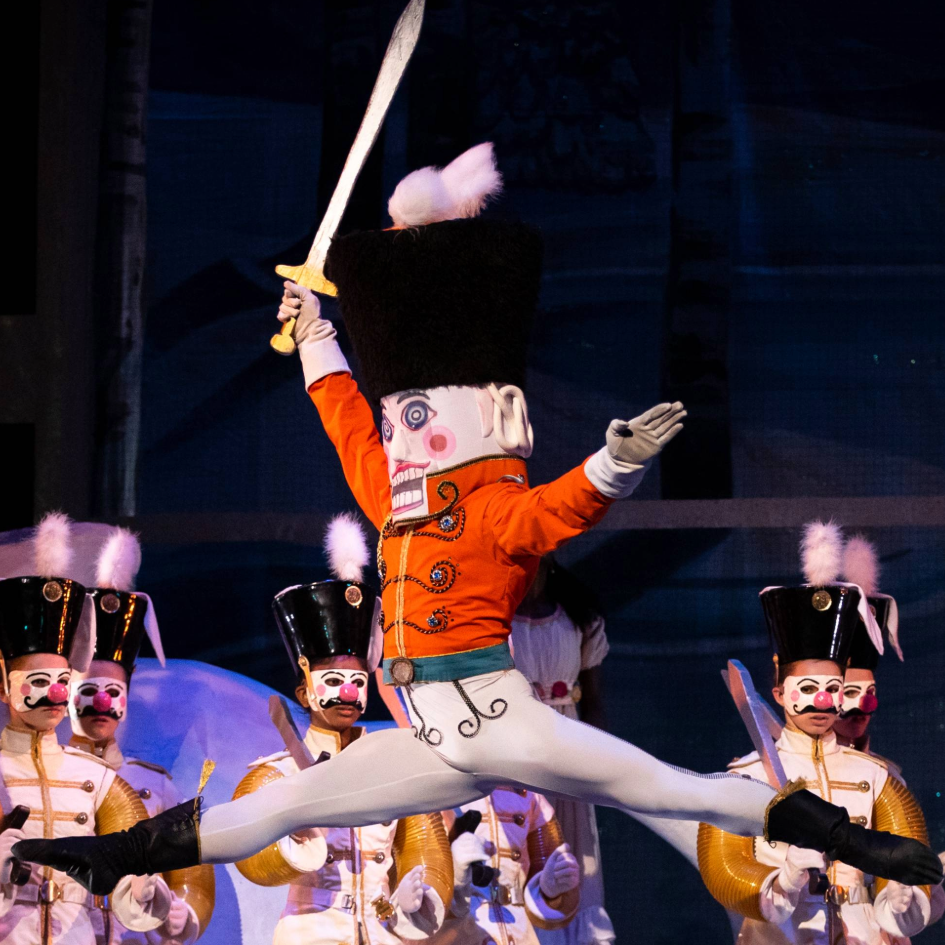 Nutcracker leaping in front of toy soldiers.