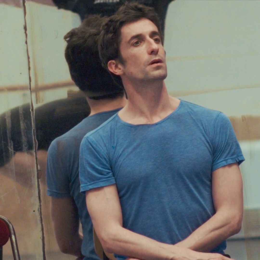 Benjamin Pech sits at the front of a ballet studio observing another dancer.
